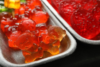 Delicious gummy bear candies in container, closeup
