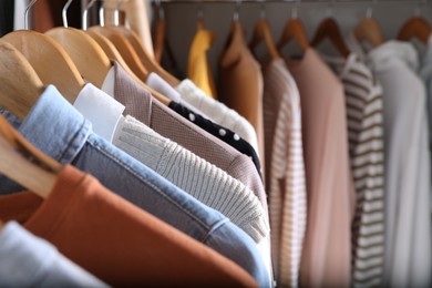 Photo of Wardrobe closet with different stylish clothes, closeup