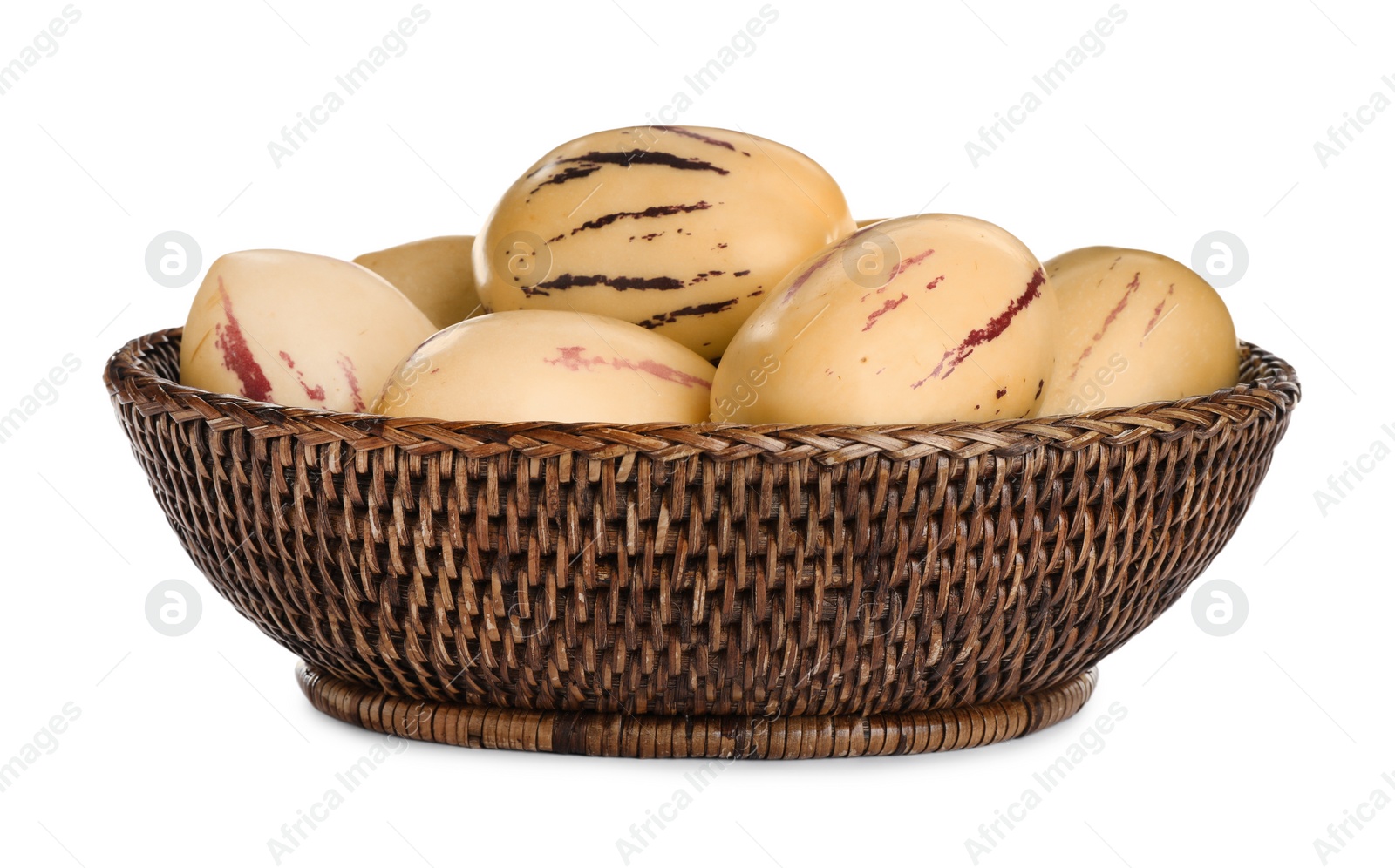 Photo of Fresh ripe pepino melons in wicker bowl on white background