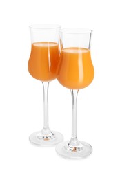 Glasses with tasty tangerine liqueur isolated on white