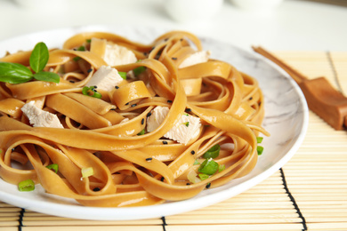 Tasty buckwheat noodles with meat served on table, closeup