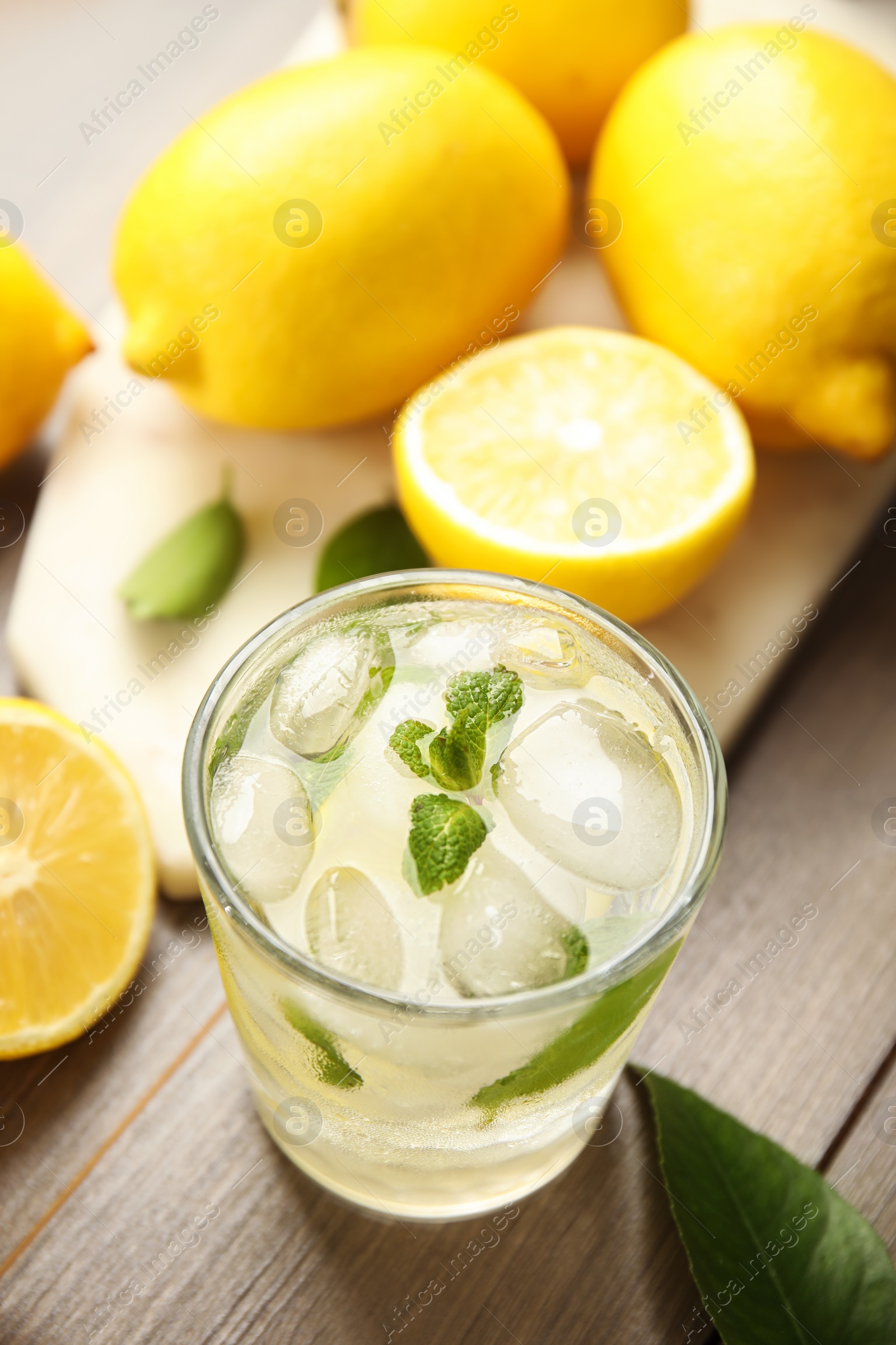 Photo of Cool freshly made lemonade and fruits on wooden table, above view