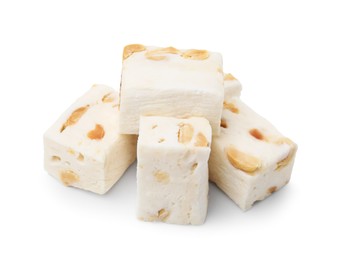 Photo of Many pieces of delicious nougat on white background