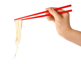 Woman holding chopsticks with tasty cooked rice noodles on white background, closeup