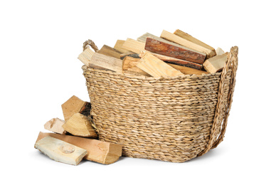 Wicker basket with cut firewood isolated on white