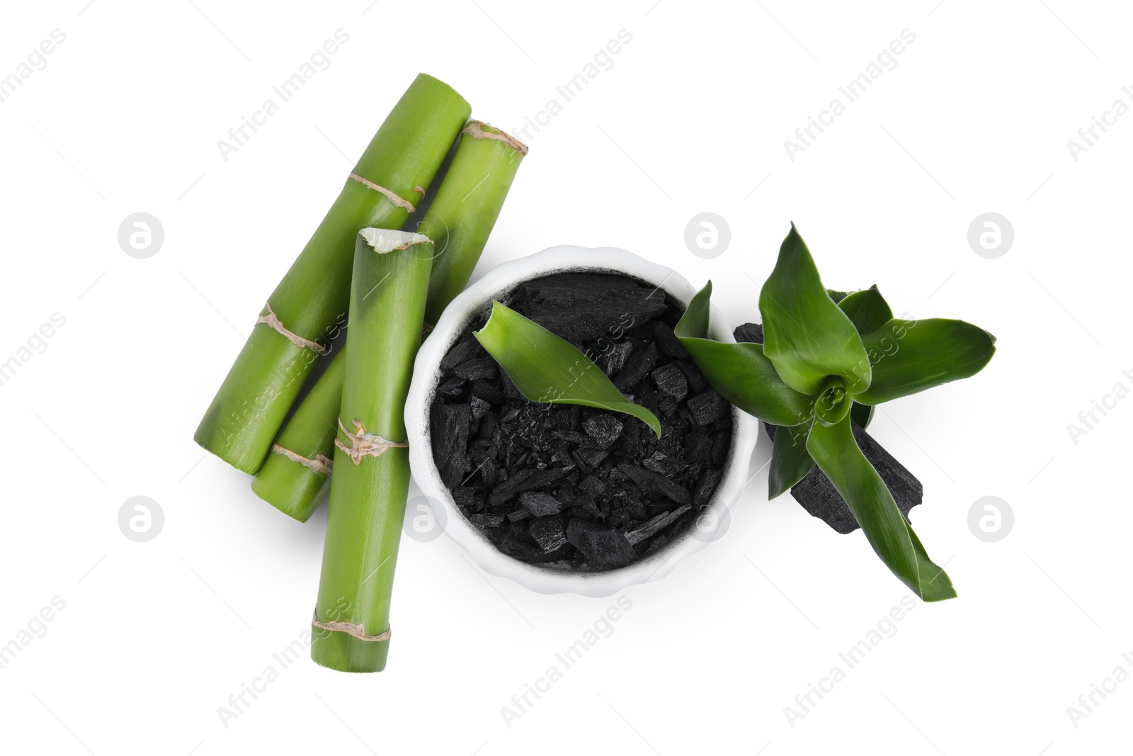 Photo of Fresh bamboo and charcoal on white background, top view