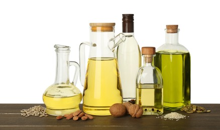 Photo of Vegetable fats. Different cooking oils and ingredients on wooden table against white background