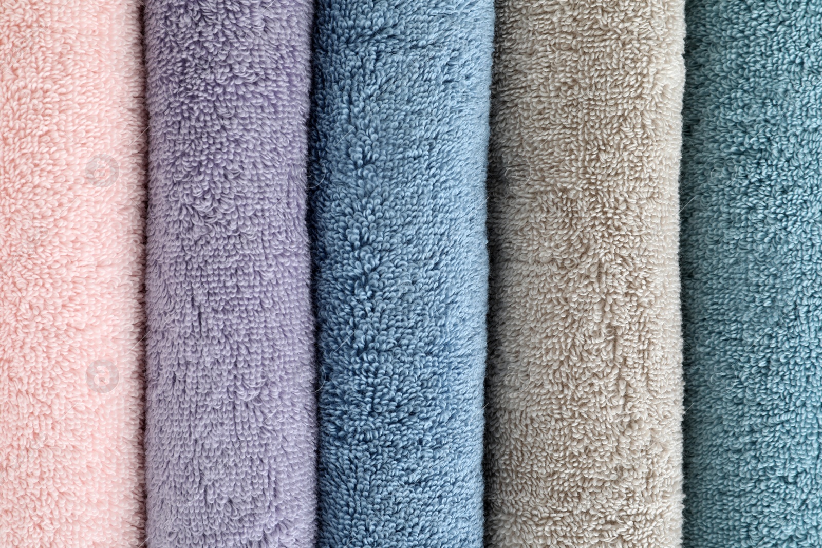 Photo of Clean soft terry towels as background, closeup