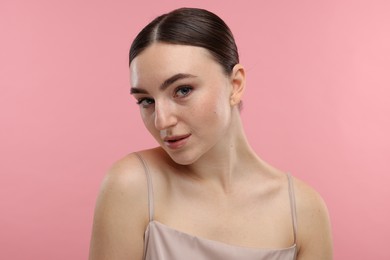 Photo of Portrait of beautiful woman on pink background