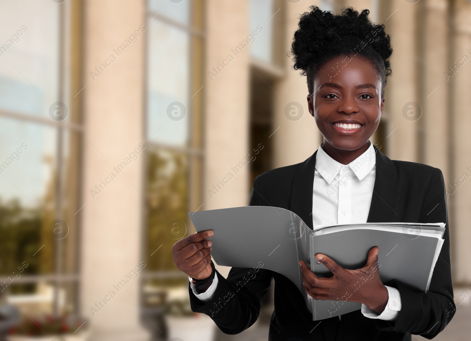 Image of Lawyer, consultant, business owner. Confident woman with file folders smiling outdoors, space for text