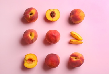 Photo of Fresh ripe peaches on pink background, flat lay