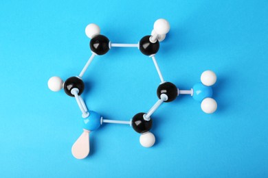 Photo of Structure of molecule on light blue background, top view. Chemical model