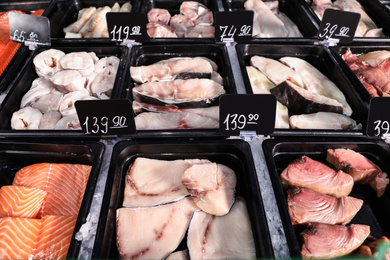 Steaks of different fresh fish in supermarket
