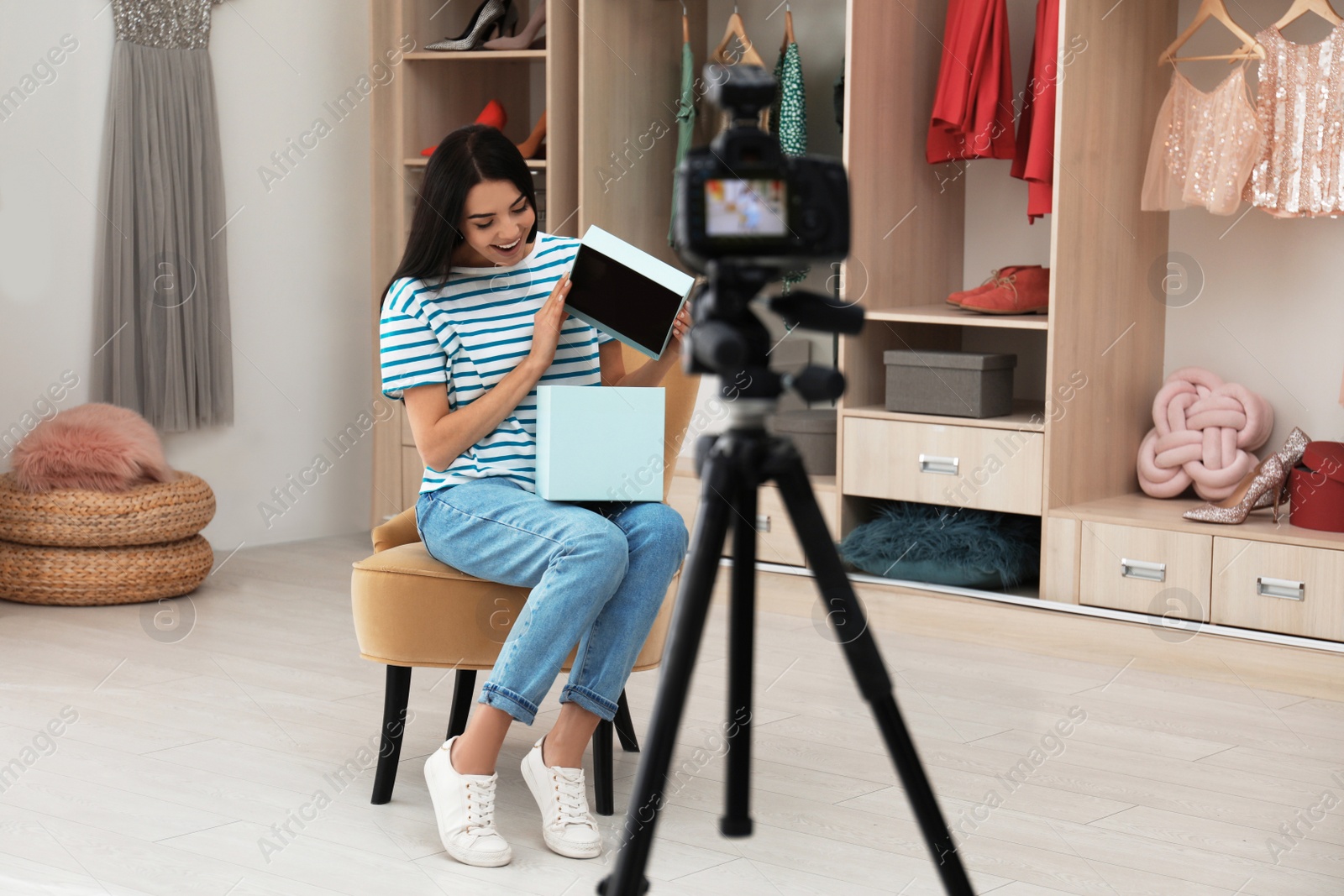 Photo of Emotional fashion blogger recording new video in room