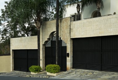 Photo of Beautiful closed metal gate and fence outdoors