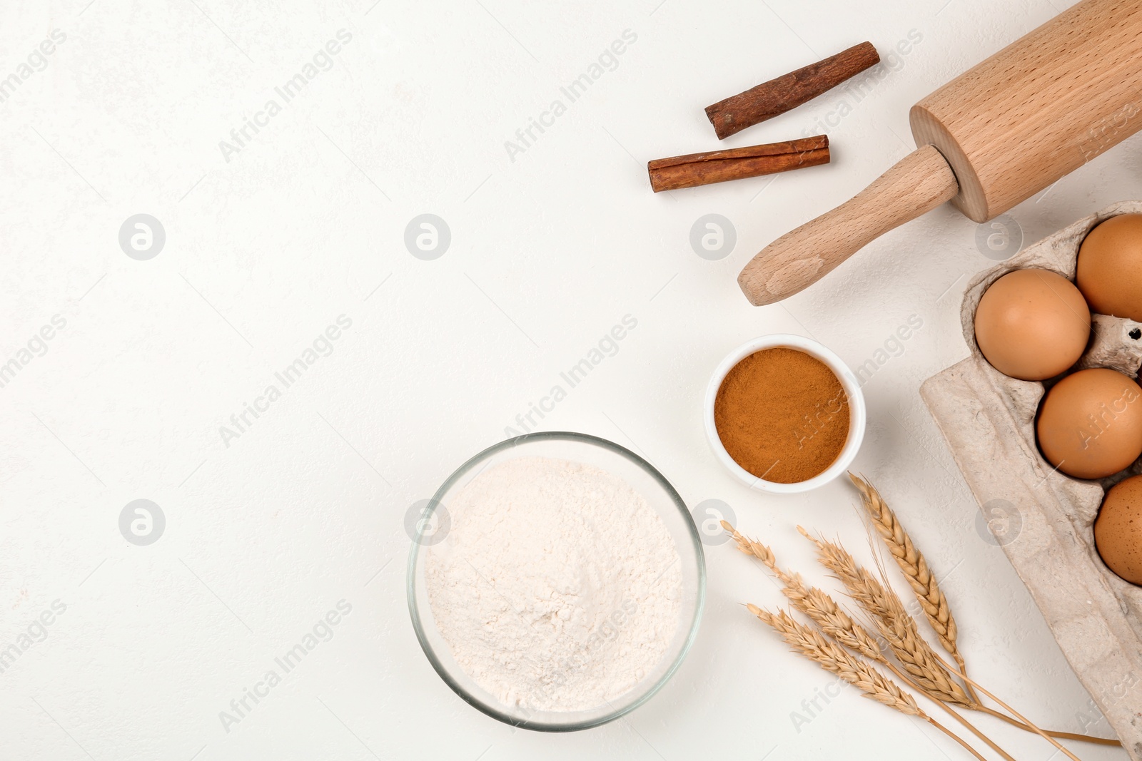 Photo of Flat lay composition with raw eggs and other ingredients on white table, space for text. Baking pie