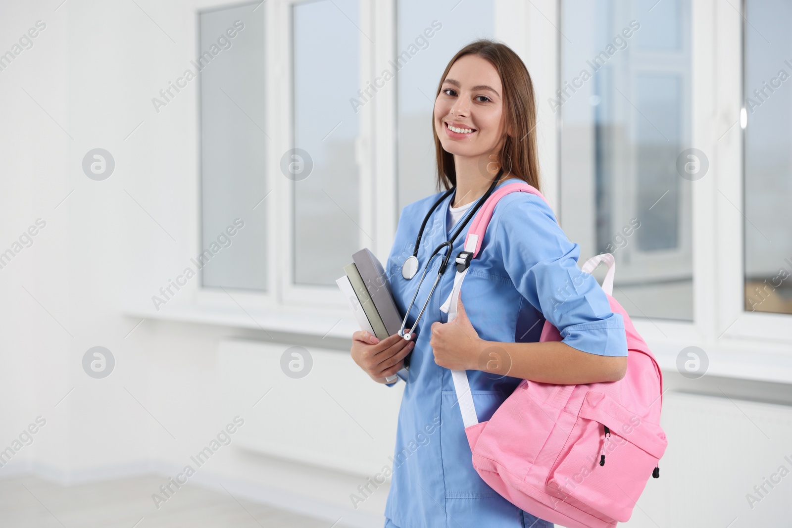 Photo of Portrait of young intern wearing uniform in university hall, space for text