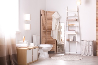 Photo of Ceramic toilet bowl in stylish bathroom. Idea for interior design