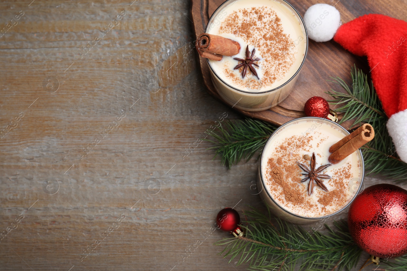 Photo of Flat lay composition with delicious Christmas liqueur on wooden table, space for text