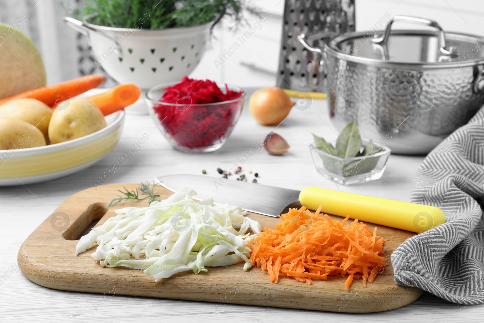 Photo of Fresh ingredients for borscht on white wooden table