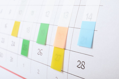 Photo of Calendar page with colorful stickers, closeup view