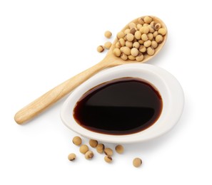 Photo of Tasty soy sauce in gravy boat, soybeans and spoon isolated on white, top view