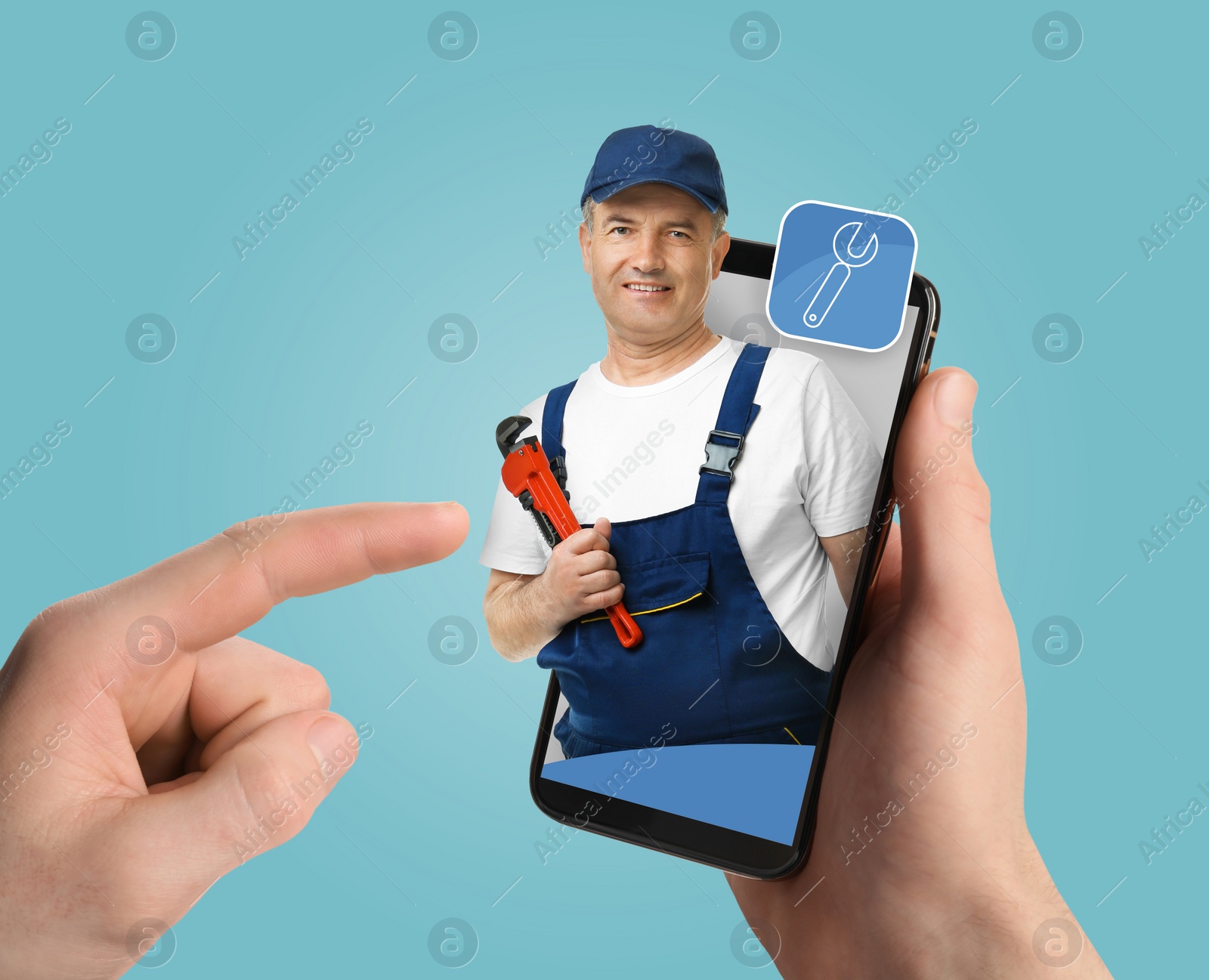 Image of Find plumber. Man using mobile phone on light blue background, closeup. Specialist looking out of gadget