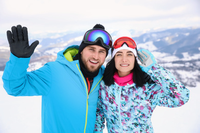 Photo of Young couple at mountain resort. Winter vacation