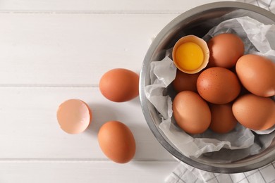 Photo of Fresh raw chicken eggs on white wooden table, flat lay. Space for text