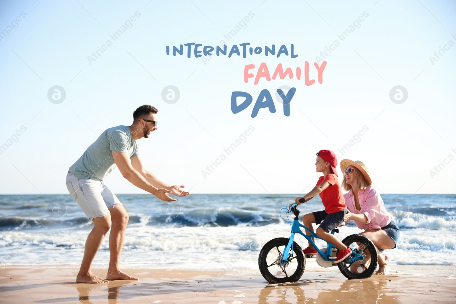 Image of Happy parents teaching son to ride bicycle on sandy beach near sea. Happy Family Day