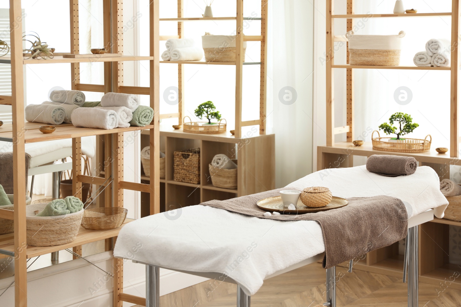 Photo of Stylish room interior with massage table in spa salon