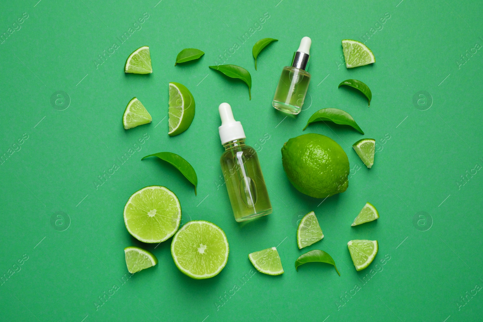 Photo of Flat lay composition with lime essential oil on green background