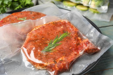 Photo of Meat in vacuum packings on wooden table, closeup