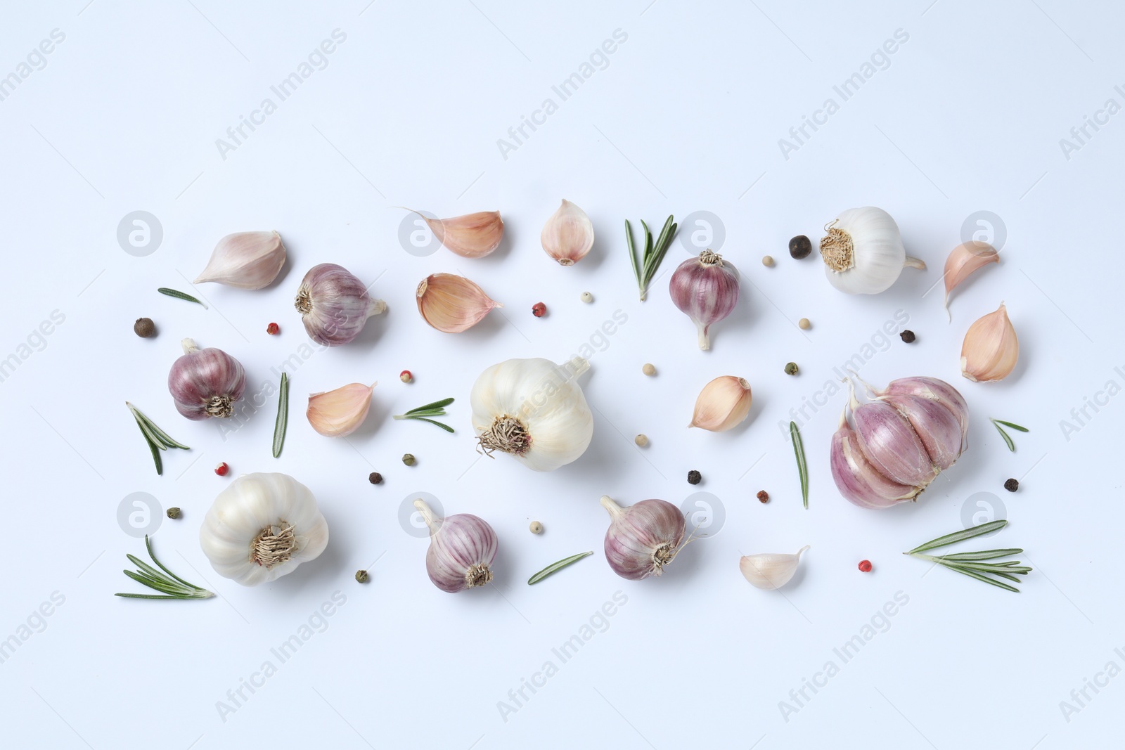 Photo of Fresh garlic, rosemary and peppercorns on white background, flat lay