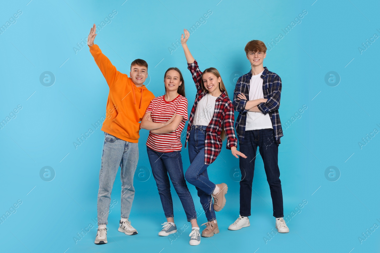 Photo of Group of teenagers on light blue background