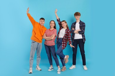 Group of teenagers on light blue background