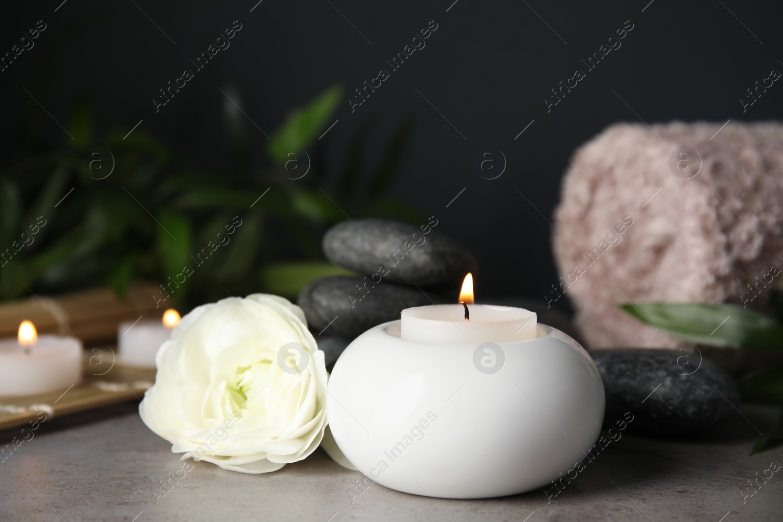 Photo of Spa composition with burning candle on table