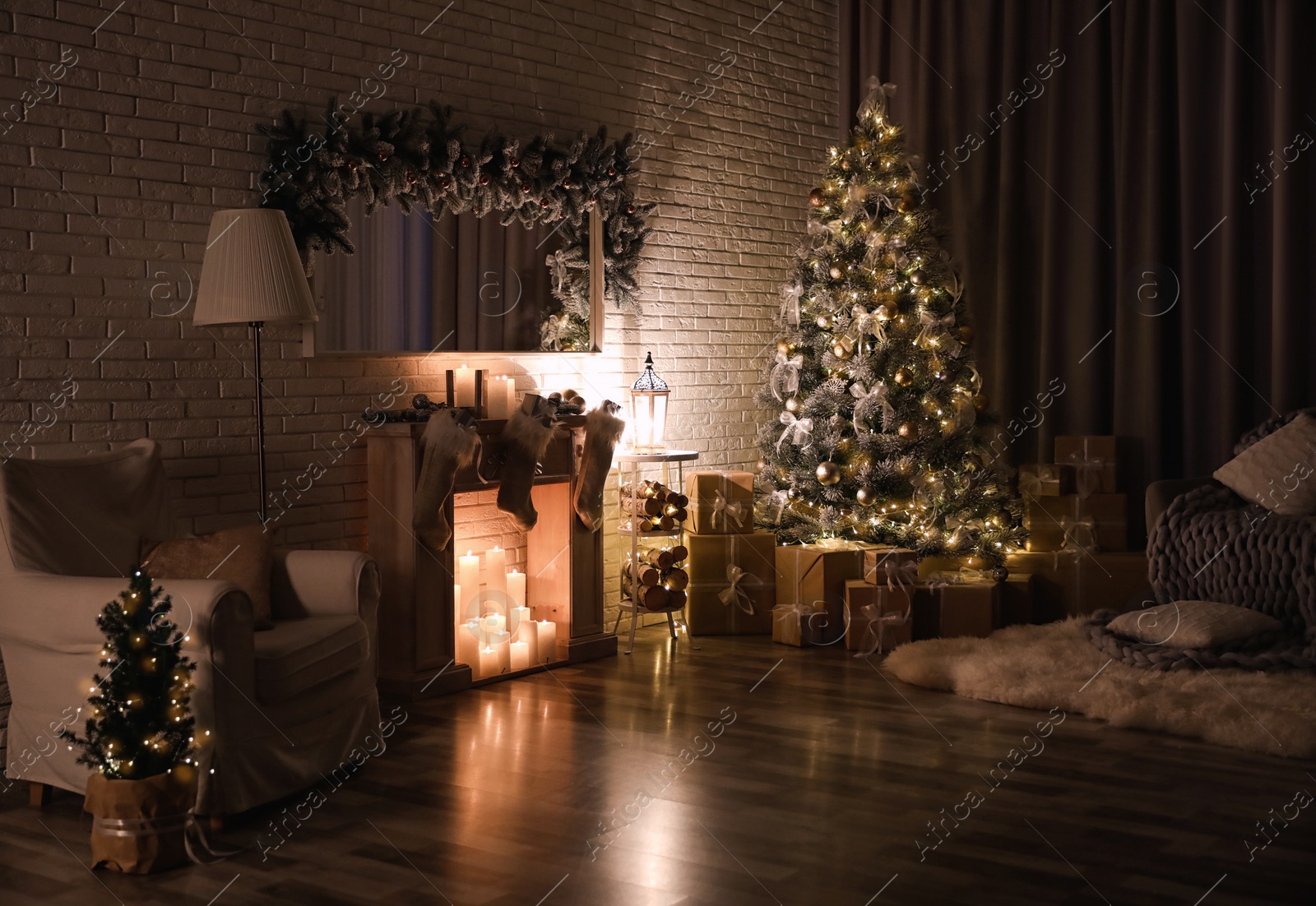 Photo of Stylish interior with beautiful Christmas tree and artificial fireplace at night