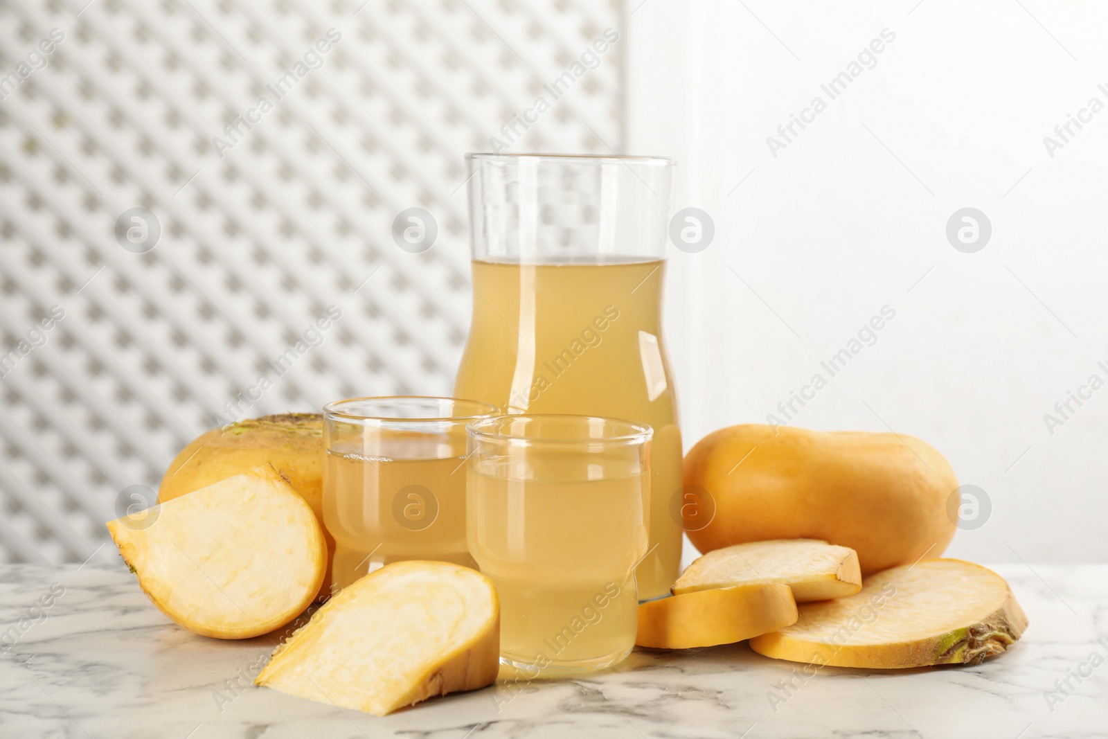 Photo of Freshly made turnip juice on white marble table