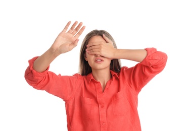 Young woman being blinded on white background