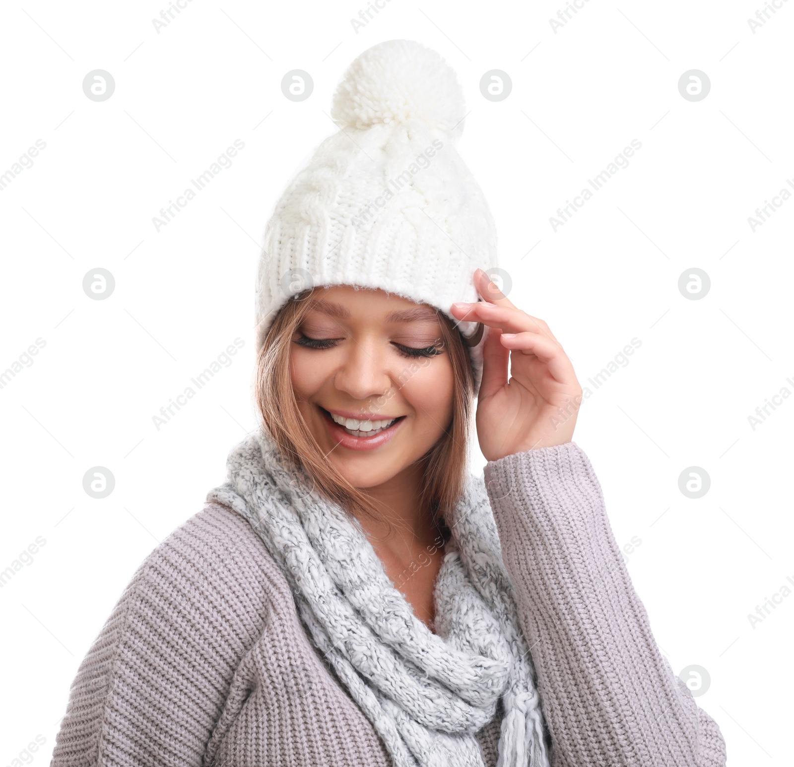 Photo of Young woman in warm sweater, scarf and hat on white background. Winter season