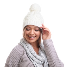 Young woman in warm sweater, scarf and hat on white background. Winter season