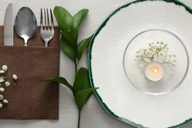 Photo of Elegant table setting with green plants on white wooden background, flat lay