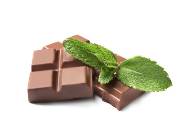 Photo of Pieces of milk chocolate with mint on white background