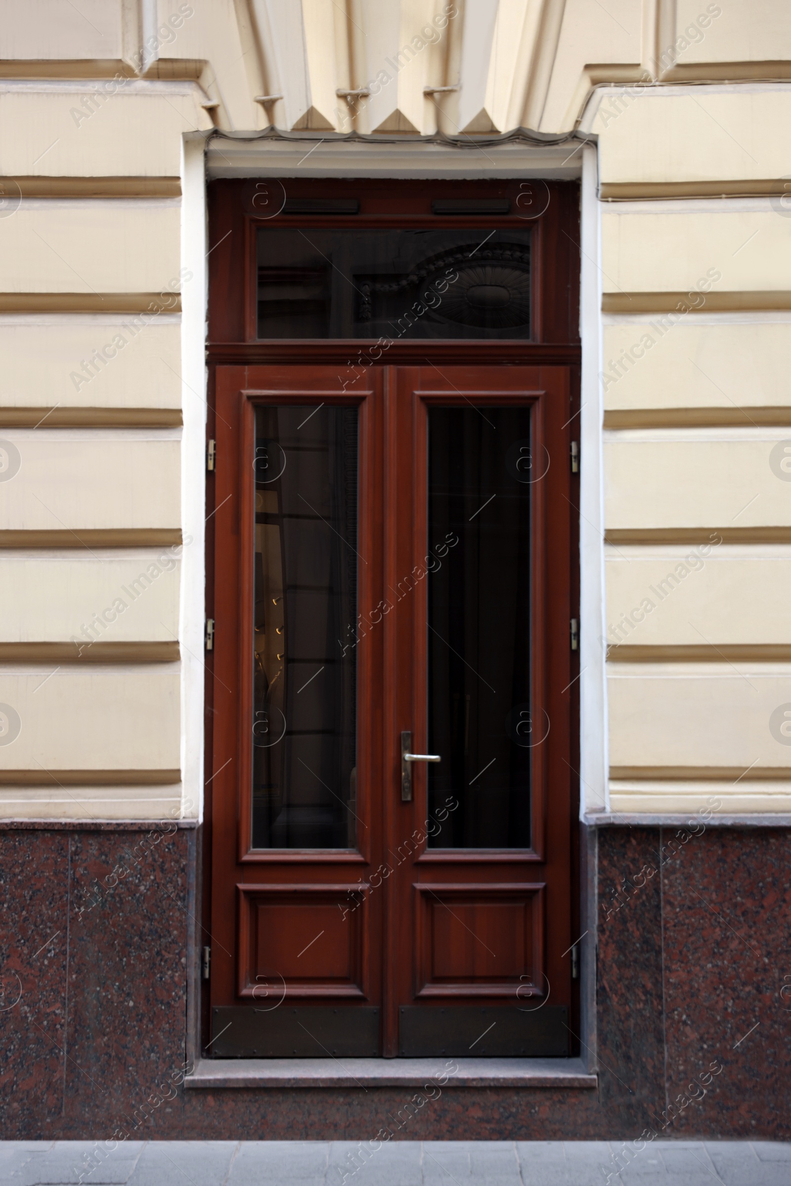 Photo of Entrance of house with beautiful wooden door and transom window