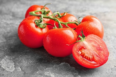 Photo of Fresh ripe red tomatoes on grey background