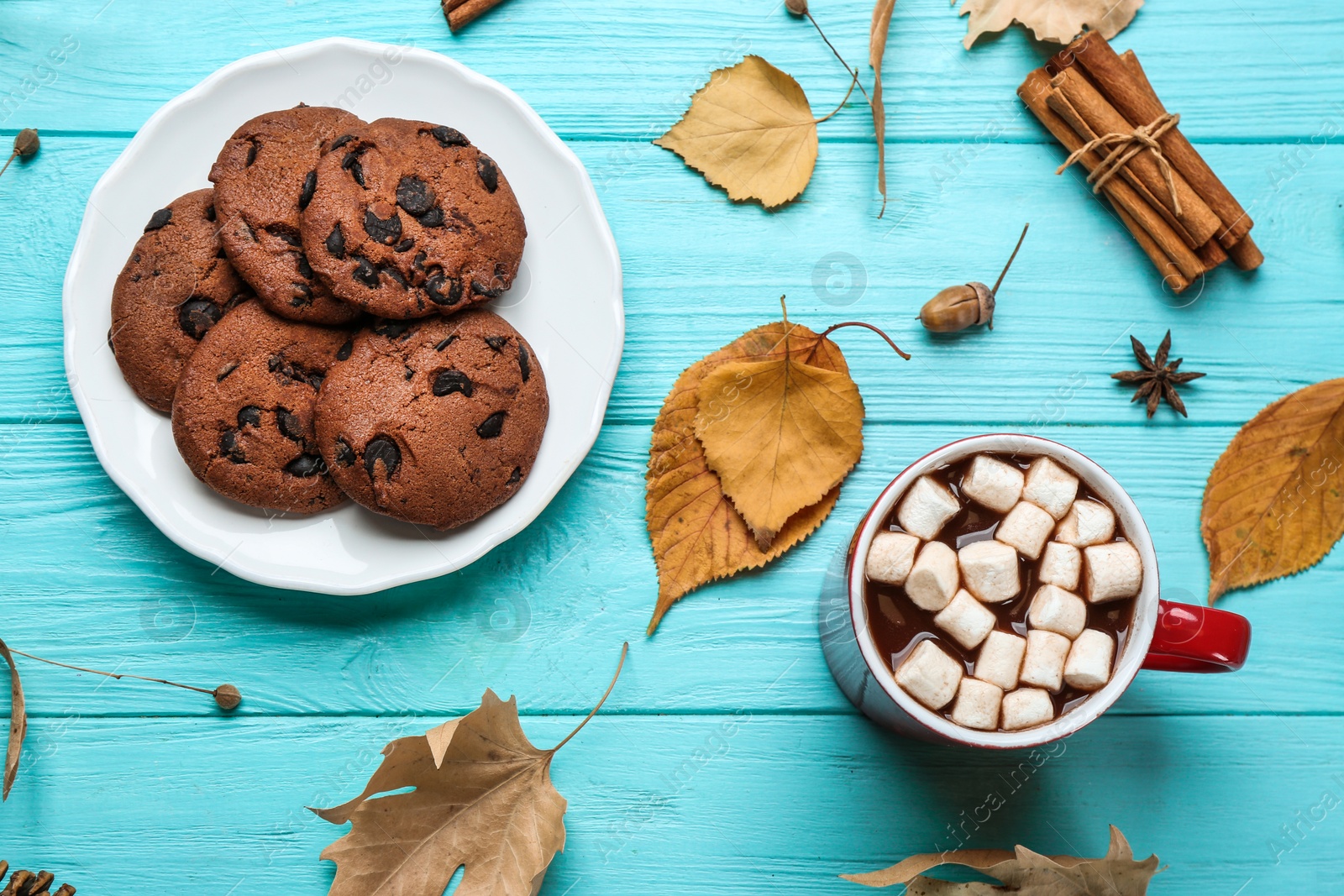 Photo of Flat lay composition with cup of hot drink on blue wooden table. Cozy autumn atmosphere