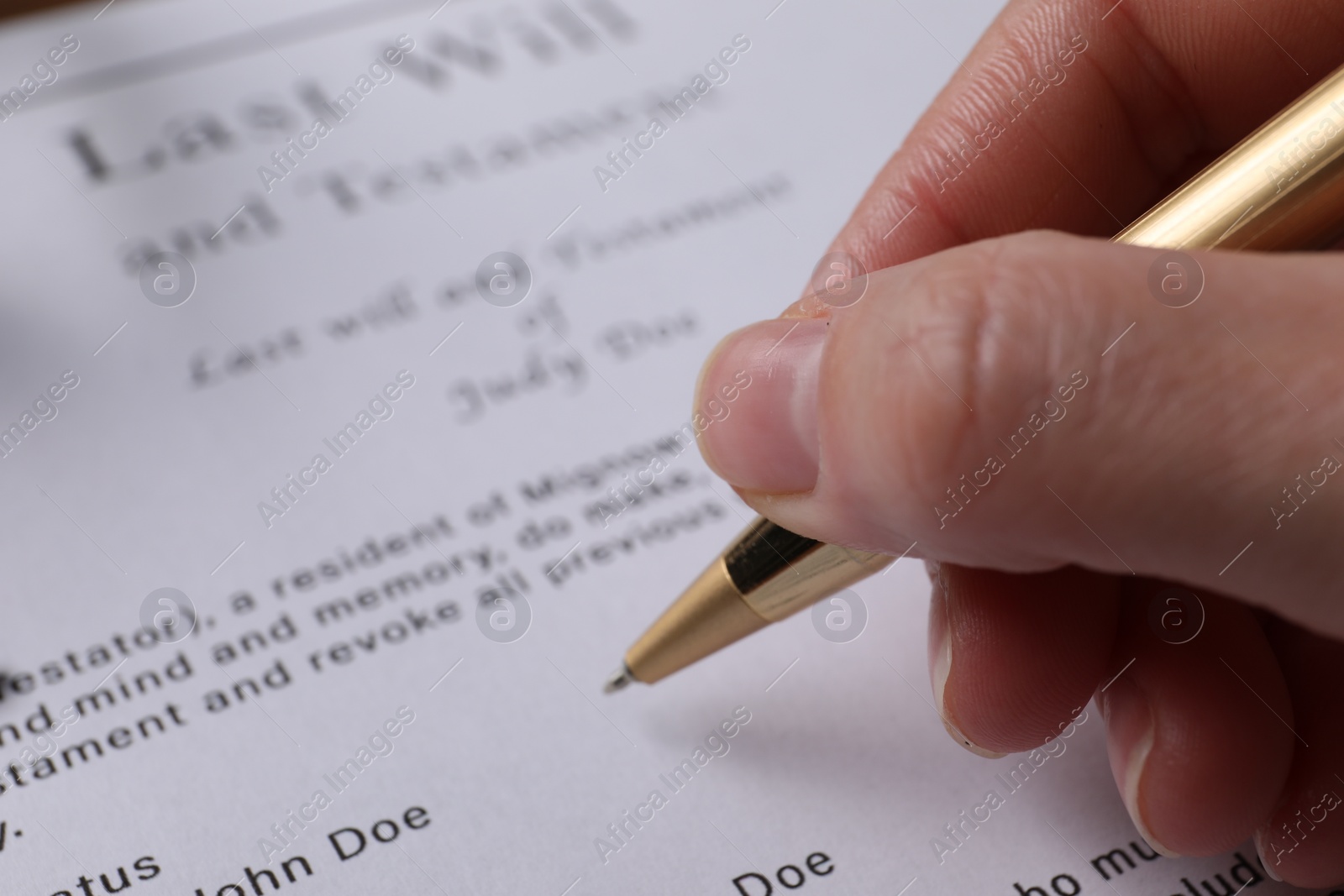 Photo of Woman signing Last Will and Testament, closeup