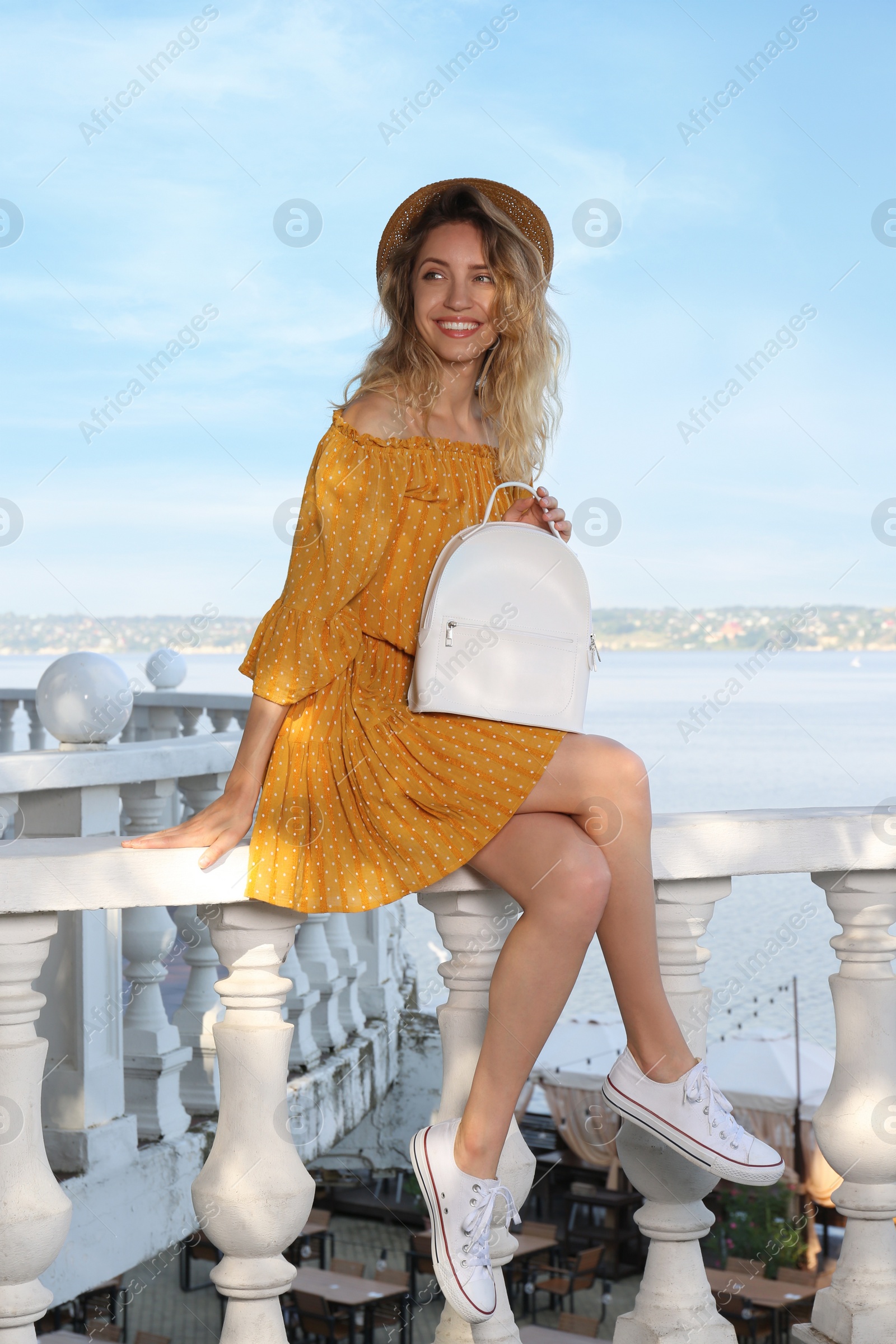 Photo of Beautiful young woman with stylish backpack outdoors