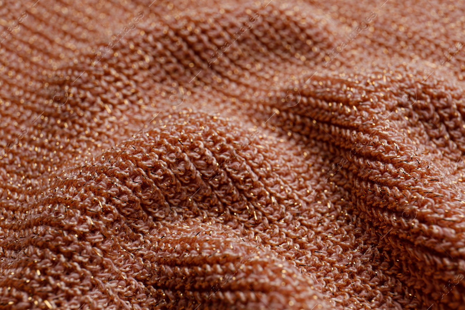 Photo of Brown knitted fabric as background, closeup view